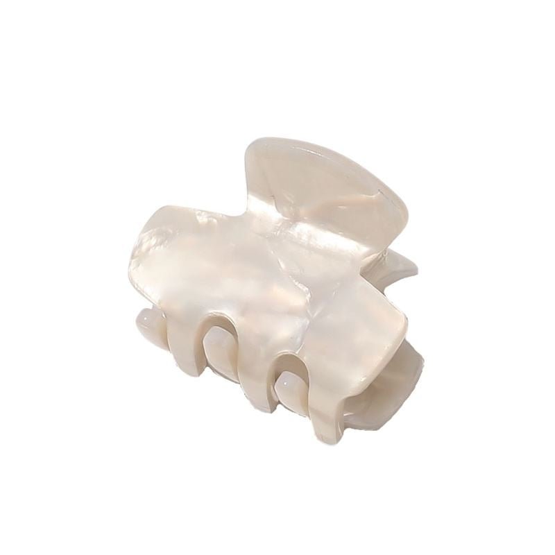 The SOHO Loa Mini Hair Claw in White Marble features a shiny, pearly-white finish and smooth, curved design with wide teeth, displayed against a plain white background.
