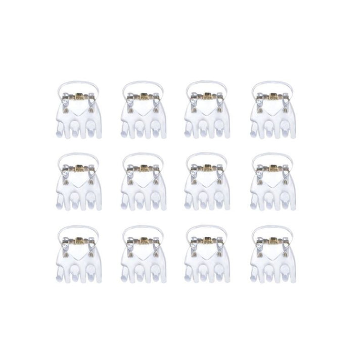 Ten SOHO Lucca Mini Hair Claws - Transparent by SOHO are arranged in four rows on a plain white background, resembling orthodontic braces with white brackets and metallic wires or neatly laid-out transparent hair clips.