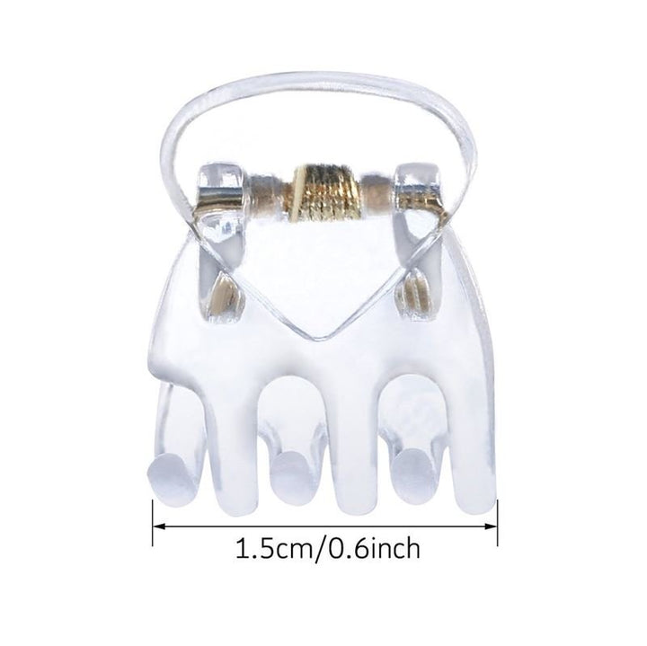 The SOHO Lucca Mini Hair Claws - Transparent by SOHO feature five rounded prongs, a gold-toned spring, and measure just 1.5 cm (0.6 in) wide—perfect for fans of mini or clear hair clips.