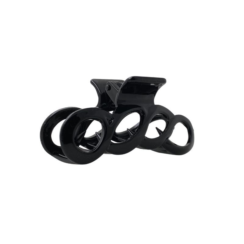 The SOHO Wave Hair Claw - Black by SOHO features four circular openings and a strong grip. Shown against a plain white background.